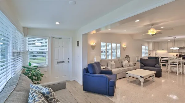 a living room with furniture and a potted plant