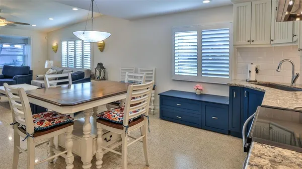 a kitchen with granite countertop a stove a sink dishwasher and cabinets with wooden floor