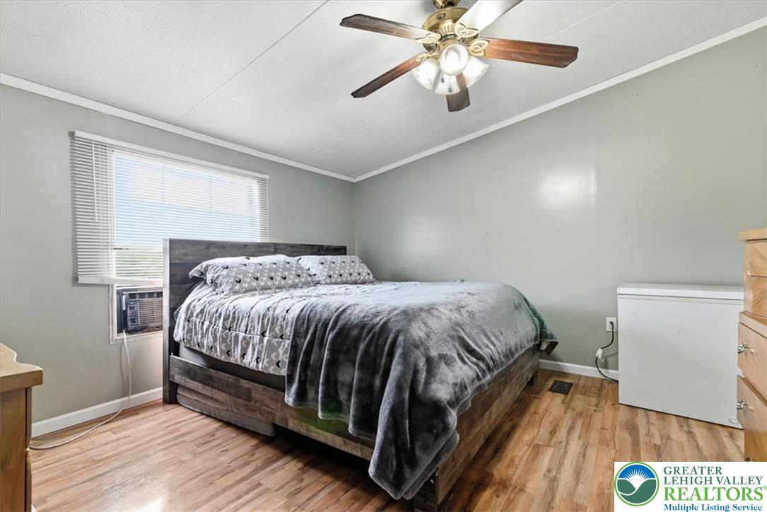 634 Main Road Lehighton, PA 18235 - Photo 19 of 39 Well-lit sleeping quarters with a ceiling fan, a window, and durable flooring.