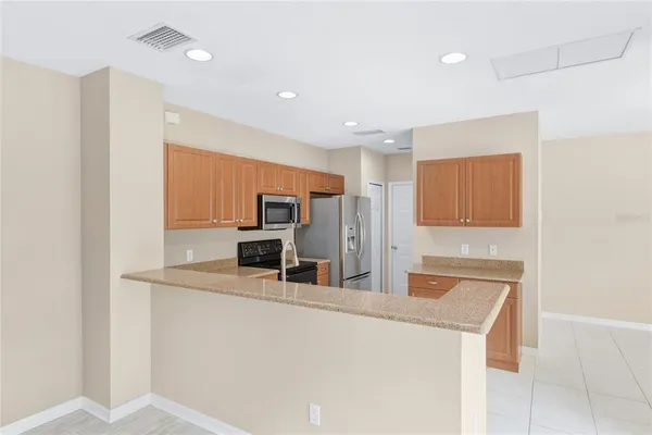a kitchen with stainless steel appliances a refrigerator and a stove