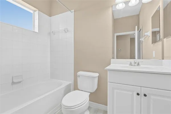 a bathroom with a sink toilet vanity and shower