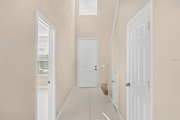 a view of a hallway with wooden floor and closet