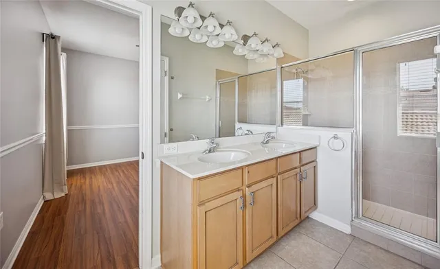 a bathroom with a sink mirror and a shower