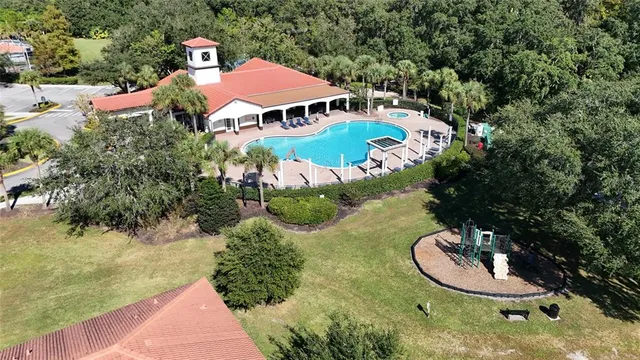a aerial view of a house with yard swimming pool and outdoor seating