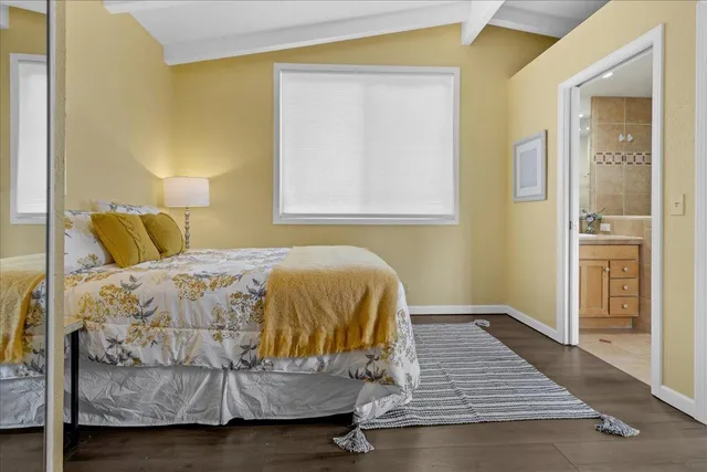 a bathroom with a granite countertop sink a toilet and shower