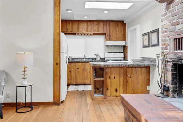 a kitchen with stainless steel appliances granite countertop a granite counter tops and a refrigerator