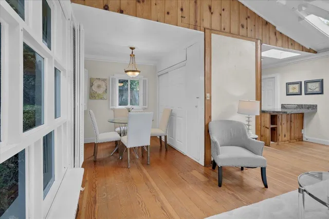 a view of a livingroom with furniture wooden floor and a chandelier
