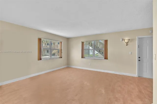 a view of a big room with window and closet