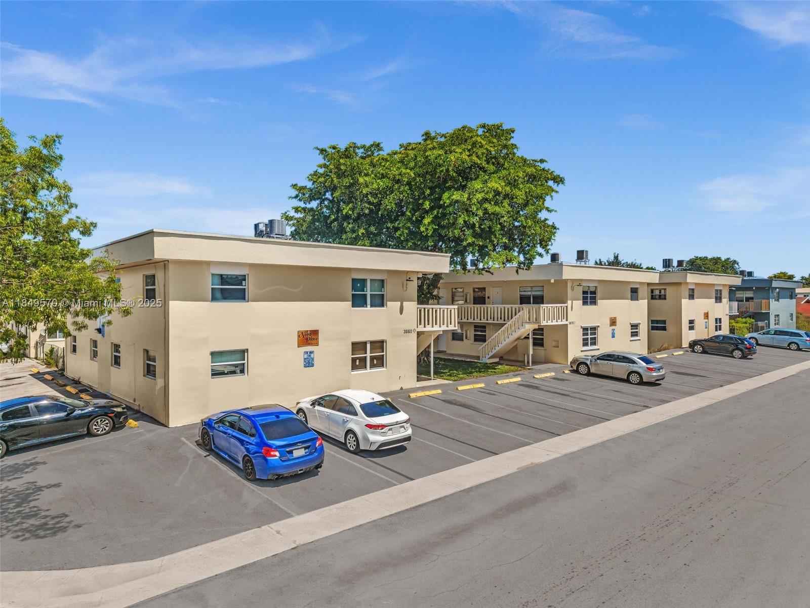 3660 Southwest 60th Avenue, Unit 2 Davie, FL 33314 - Photo 2 of 34 a view of a white house that has a car parked in it