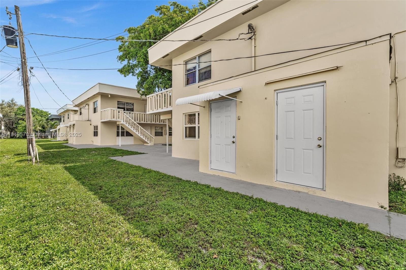 3660 Southwest 60th Avenue, Unit 2 Davie, FL 33314 - Photo 30 of 34 a front view of a house with a yard