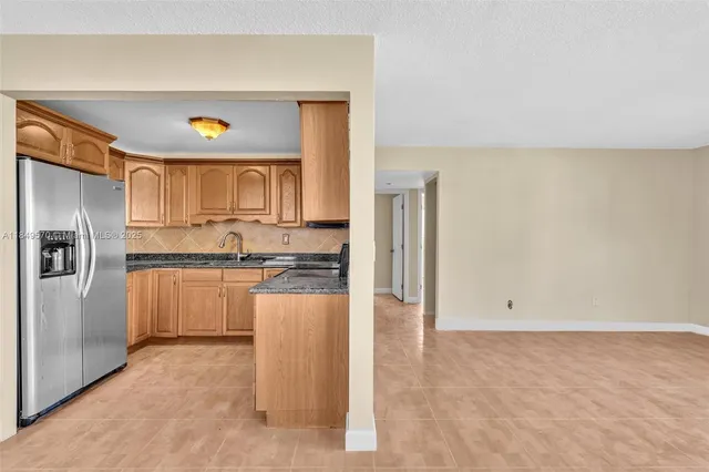 a kitchen with a refrigerator and microwave