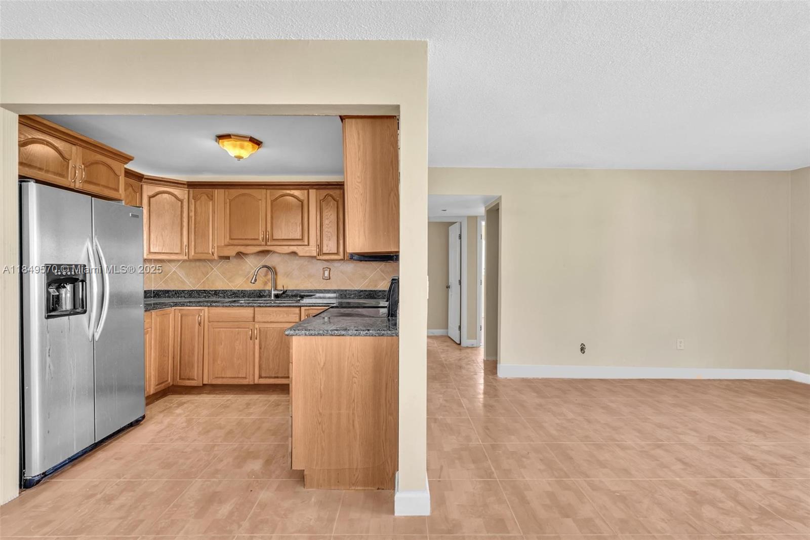 3660 Southwest 60th Avenue, Unit 2 Davie, FL 33314 - Photo 6 of 34 a kitchen with a refrigerator and microwave