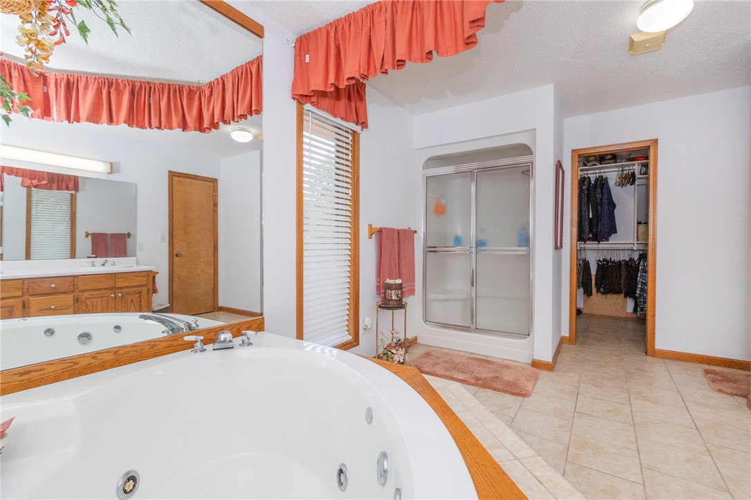 202 Plantation Point Anderson, SC 29625 - Photo 28 of 48 Relaxation awaits in this primary bathroom featuring a spacious jetted tub and an integrated shower.