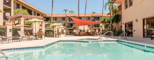 a view of a swimming pool with a lawn chairs