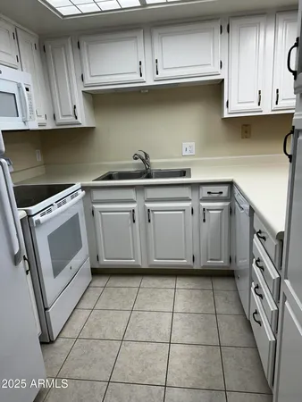 a kitchen with cabinets and appliances