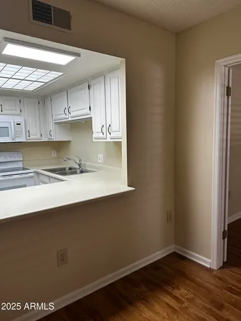 a view of kitchen with wooden floor