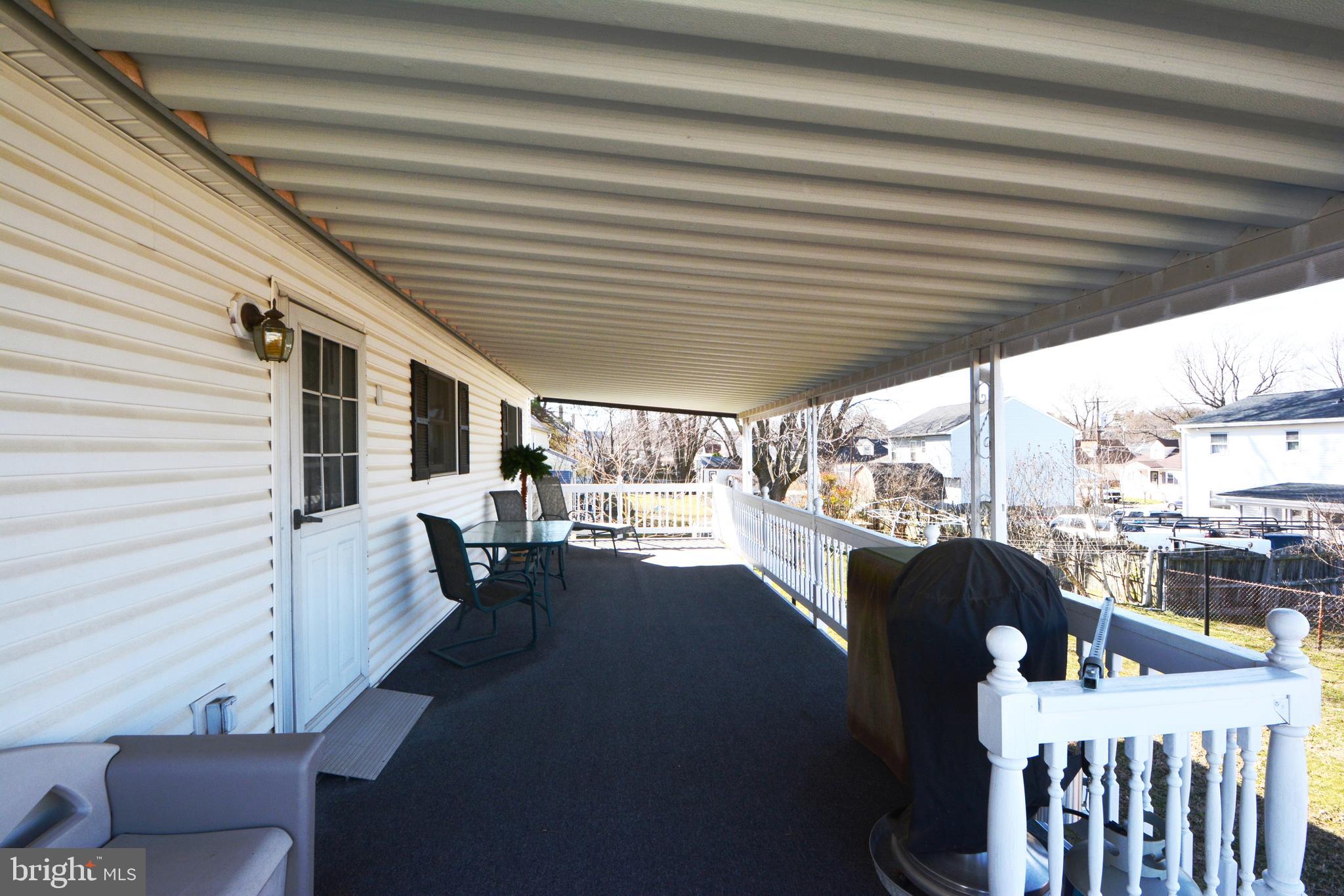 312 Holy Cross Road Baltimore, MD 21225 - Photo 3 of 68 Carpeted 32 x 10 roof covered deck off the kitchen