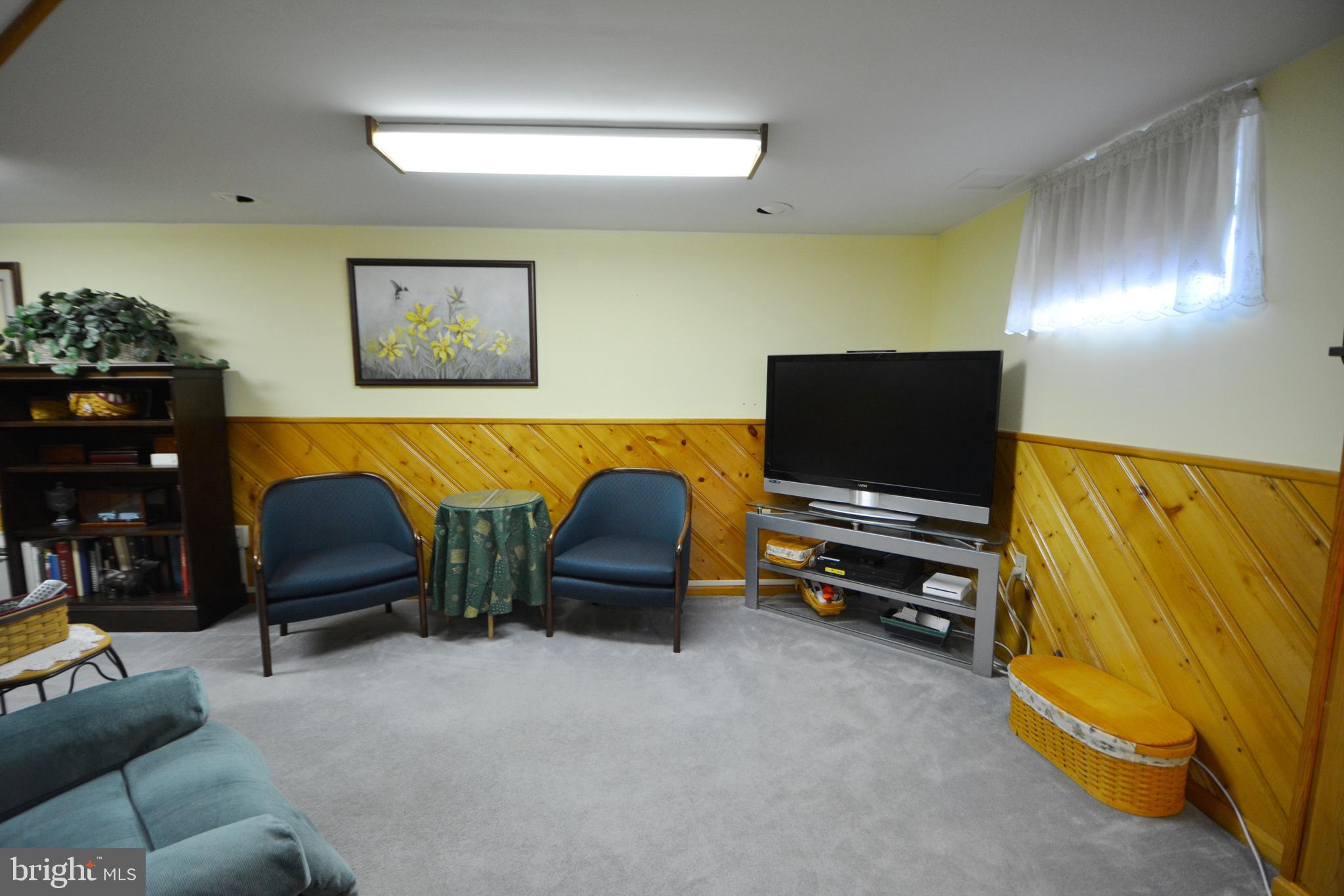 312 Holy Cross Road Baltimore, MD 21225 - Photo 49 of 68 Gray carpet in a bright & cheery family room.