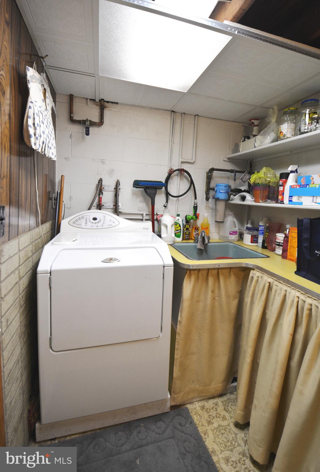 312 Holy Cross Road Baltimore, MD 21225 - Photo 58 of 68 Washer has slop sink w/ water filter & shelving