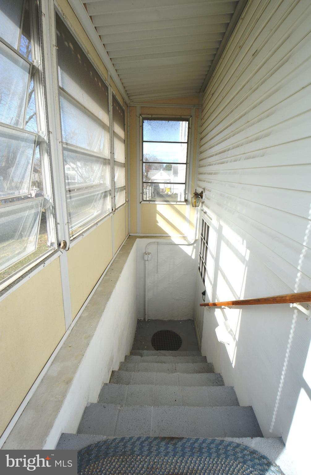 312 Holy Cross Road Baltimore, MD 21225 - Photo 60 of 68 Enclosed exterior staircase to basement w/ drain