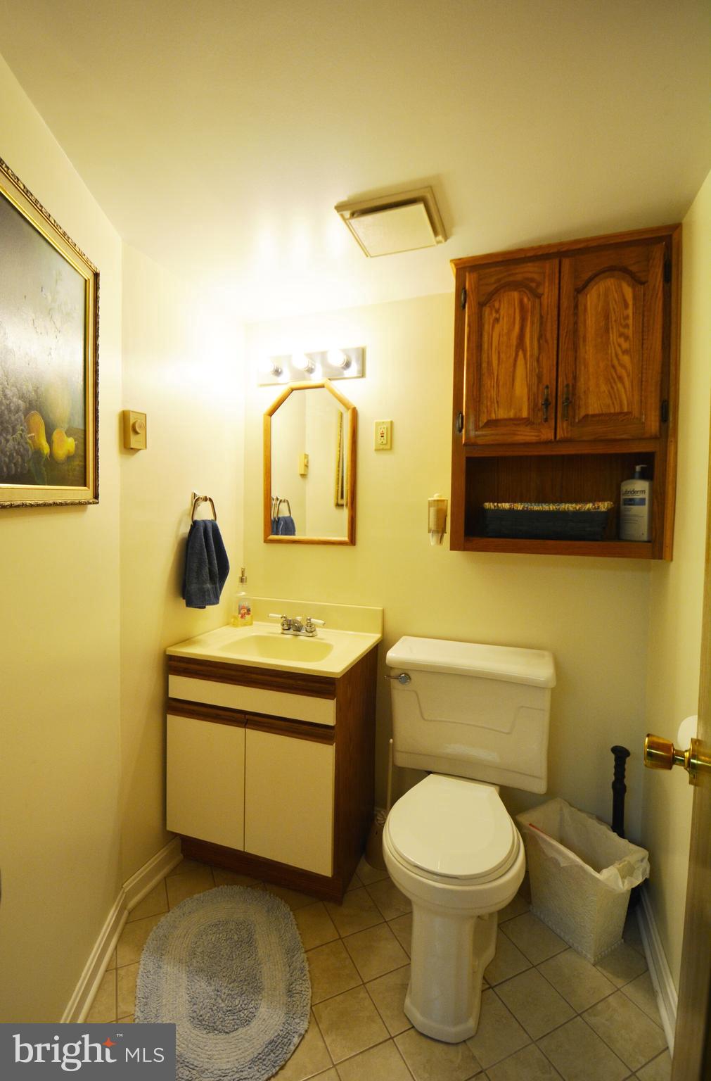 312 Holy Cross Road Baltimore, MD 21225 - Photo 9 of 68 Lower level half bath, tile flr, oak wall cabinet