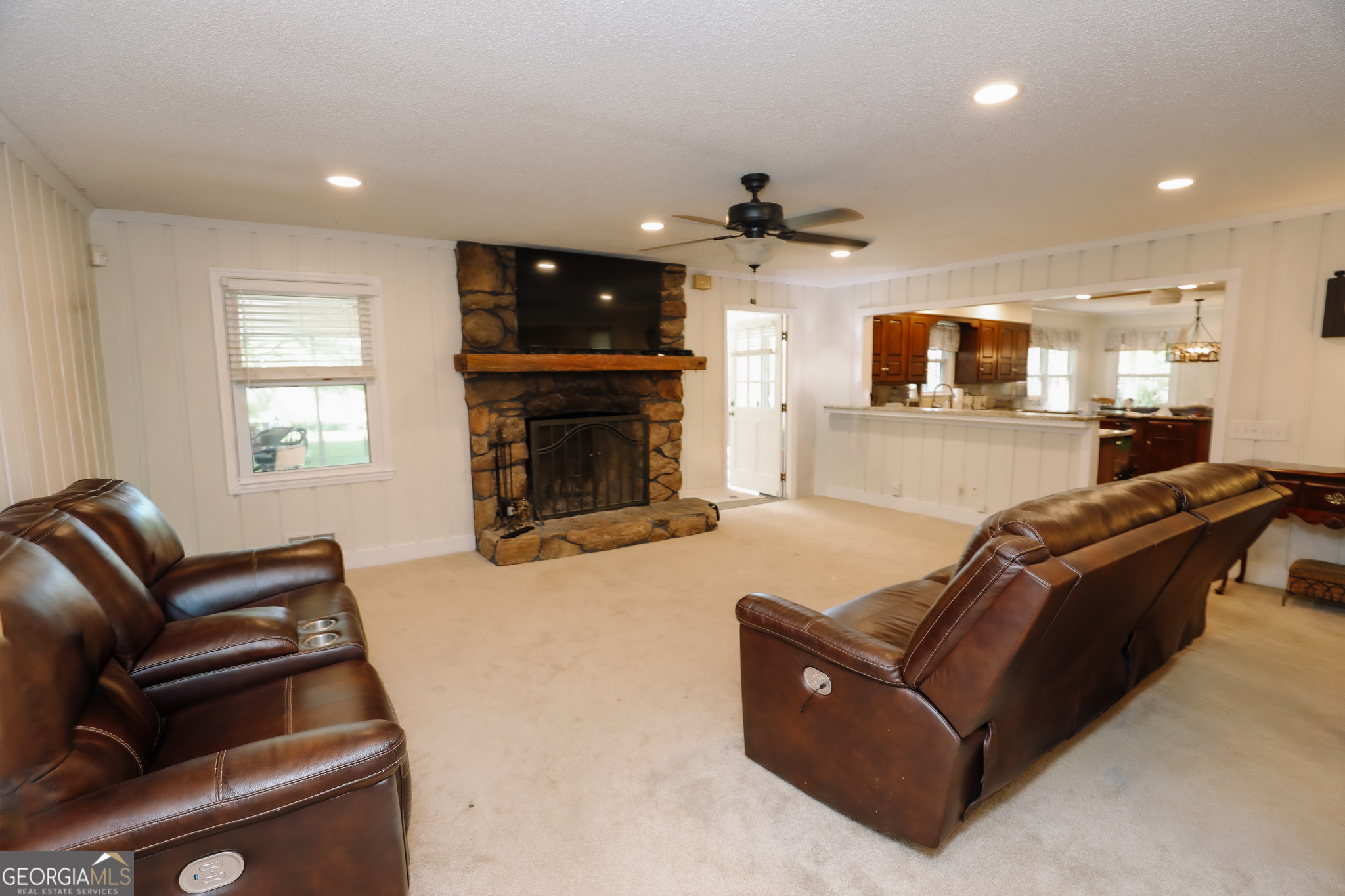 1017 Dr Bruce Jackson Road Newnan, GA 30263 - Photo 11 of 52 a living room with furniture a fireplace and a flat screen tv