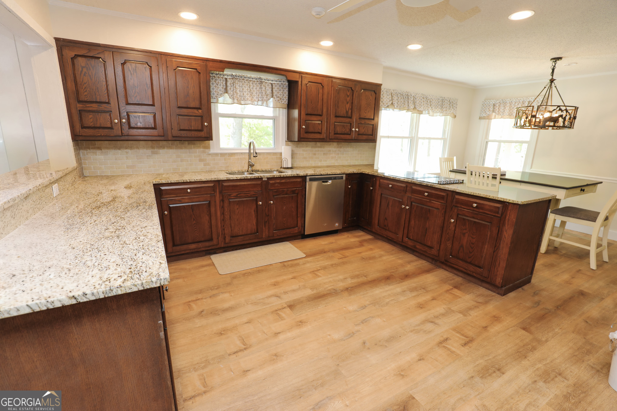 1017 Dr Bruce Jackson Road Newnan, GA 30263 - Photo 12 of 52 a kitchen with stainless steel appliances granite countertop wooden cabinets a stove top oven a sink and dishwasher