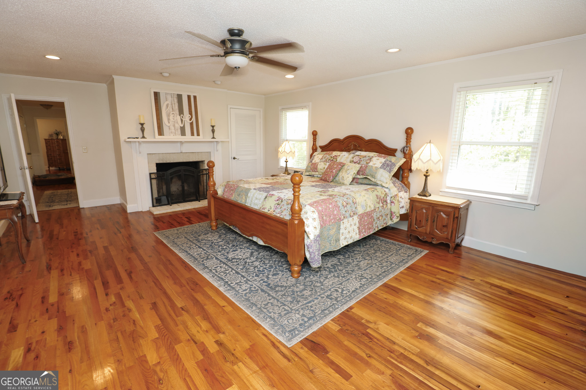 1017 Dr Bruce Jackson Road Newnan, GA 30263 - Photo 17 of 52 a spacious bedroom with a bed and a fireplace