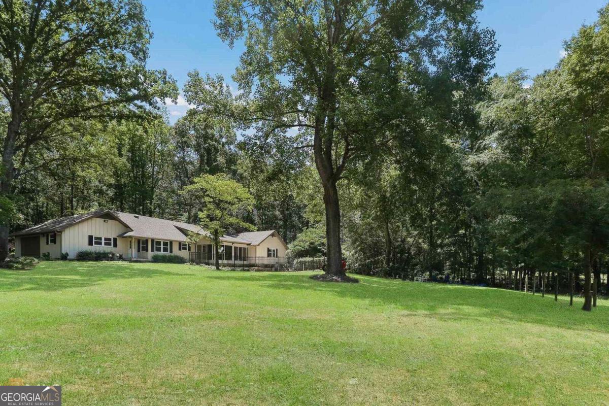 1017 Dr Bruce Jackson Road Newnan, GA 30263 - Photo 2 of 52 a view of a house with a yard