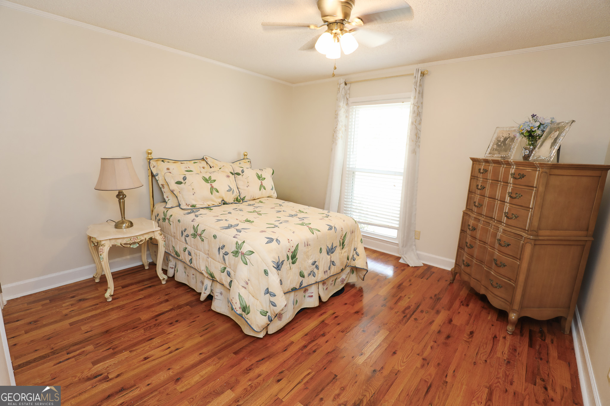 1017 Dr Bruce Jackson Road Newnan, GA 30263 - Photo 21 of 52 a bedroom with a bed and wooden floor
