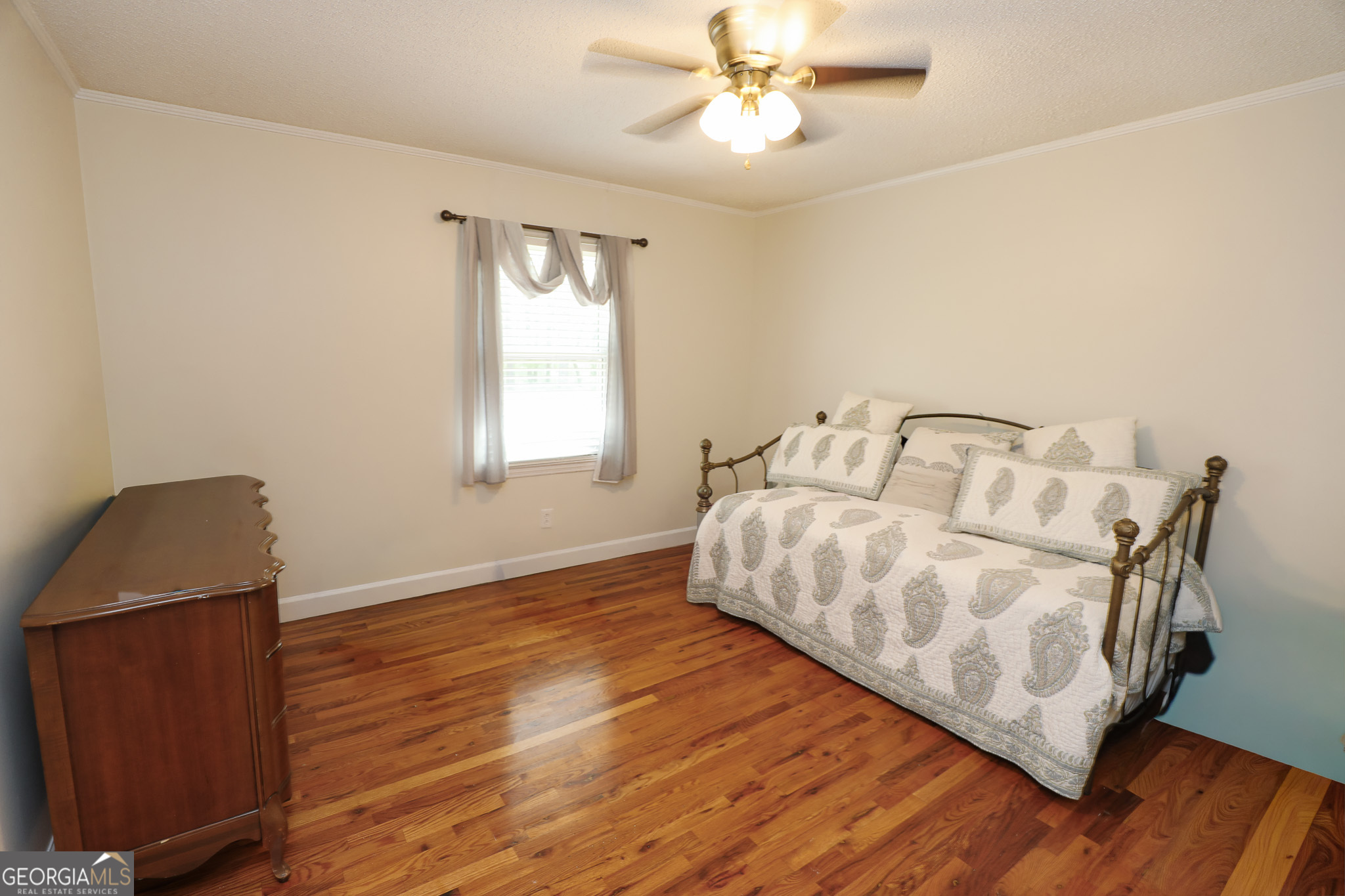 1017 Dr Bruce Jackson Road Newnan, GA 30263 - Photo 24 of 52 a bedroom with a bed and wooden floor