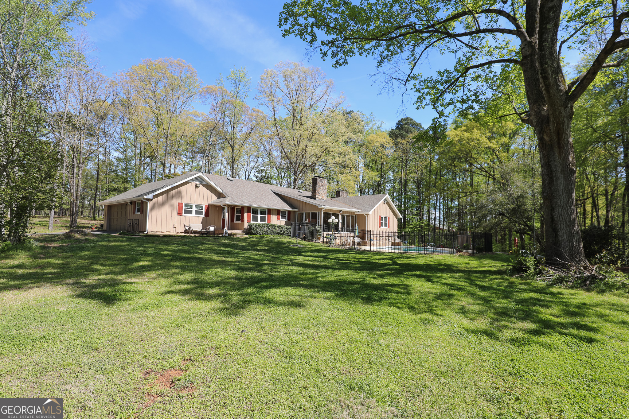 1017 Dr Bruce Jackson Road Newnan, GA 30263 - Photo 38 of 52 a view of a big house with a big yard and large trees