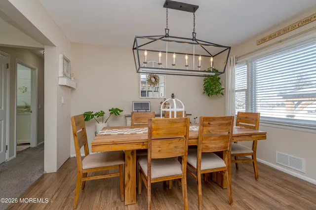 a view of a dining room with furniture wooden floor and a chandelier