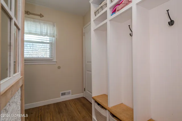 a view of room with window and wooden floor