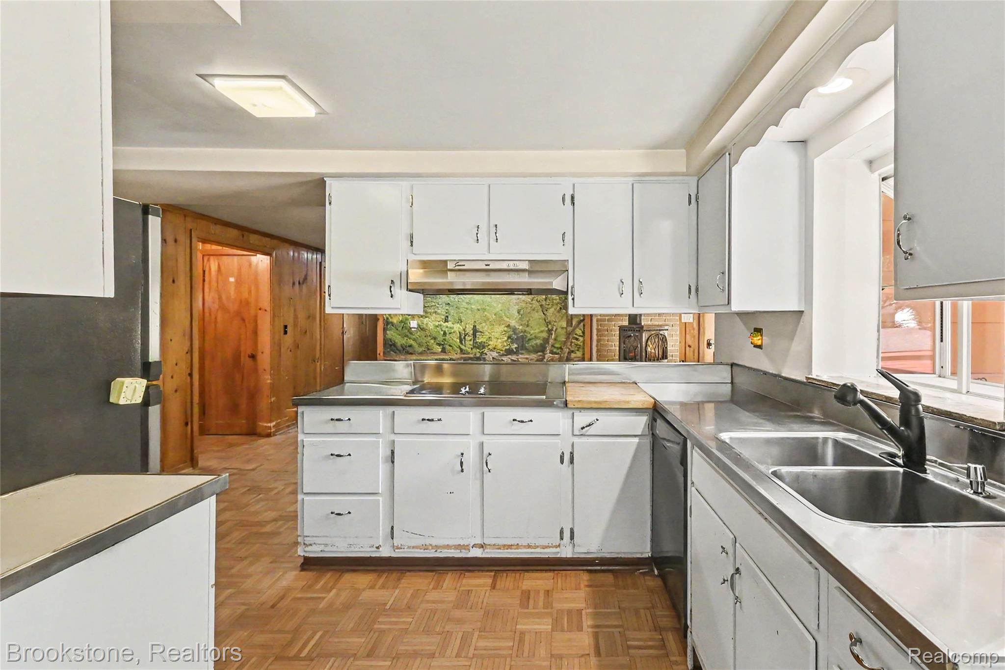 416 East Maple Street Mason, MI 48854 - Photo 5 of 18 Kitchen featuring white cabinetry, stainless steel countertops, and a dual-basin stainless steel sink