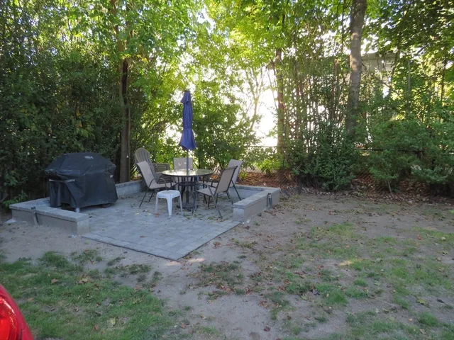 a view of a backyard with sitting area