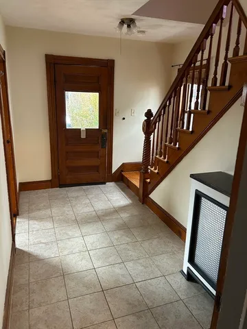 a view of an entryway with wooden floor and stairs
