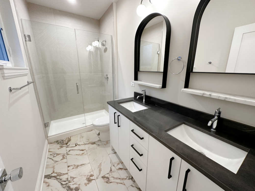 4315 South Indiana Avenue, Unit 2 Chicago, IL 60653 - Photo 11 of 16 a bathroom with a double vanity sink toilet and shower