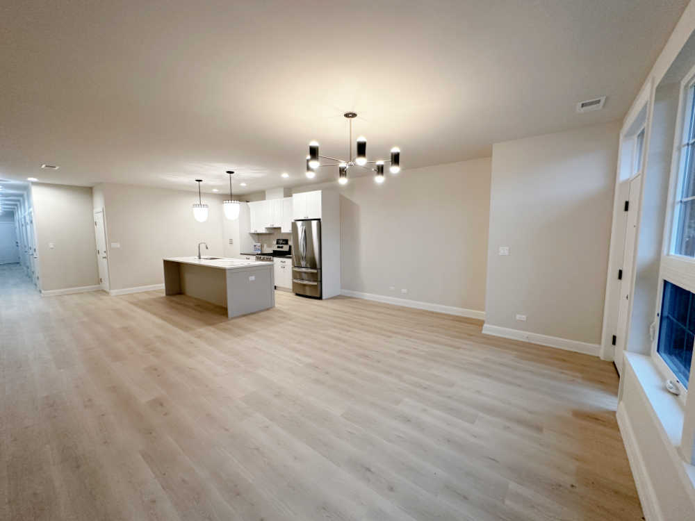 4315 South Indiana Avenue, Unit 2 Chicago, IL 60653 - Photo 4 of 16 a view of a kitchen with a sink and a large mirror