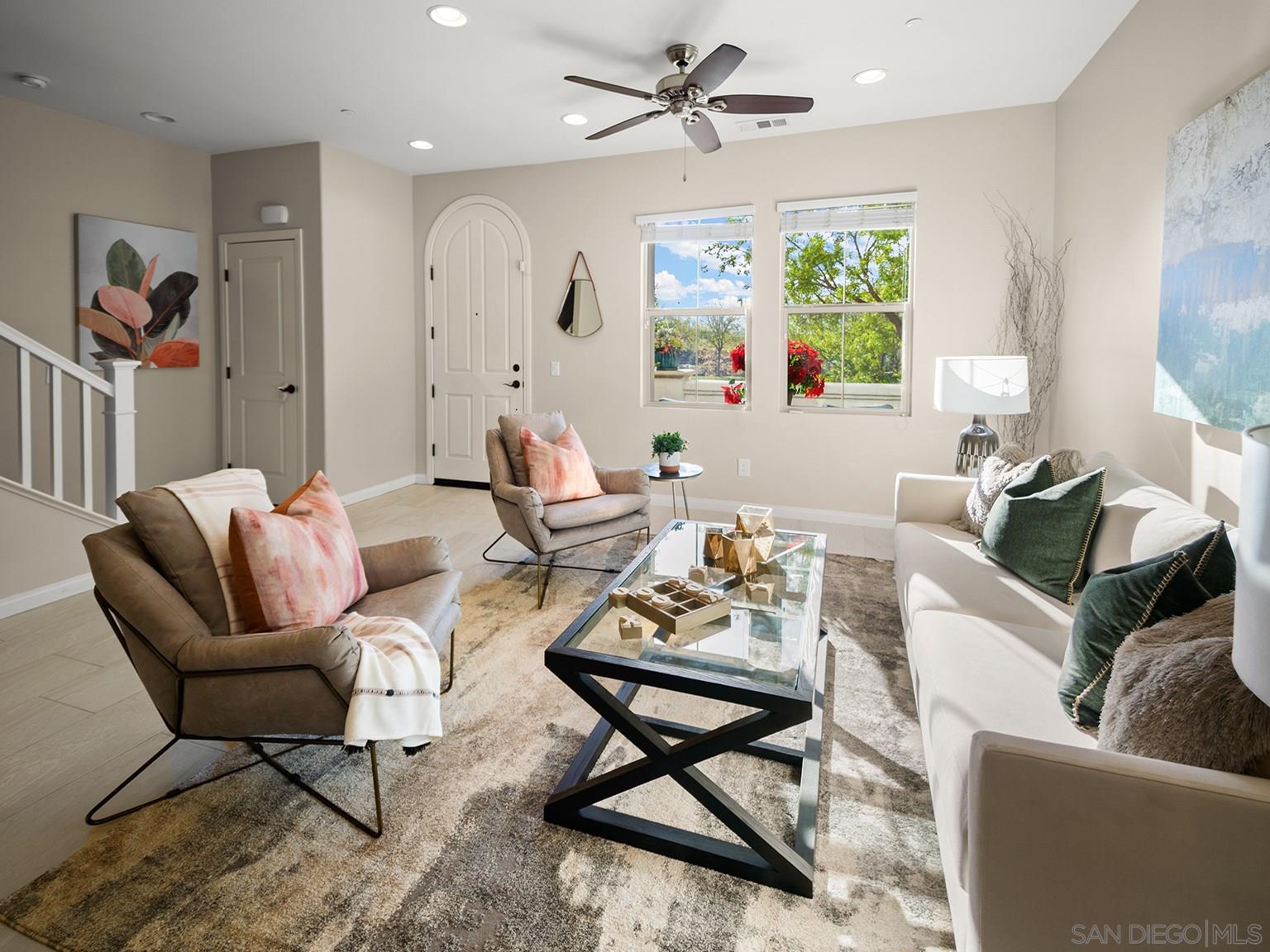 a living room with furniture and a large window