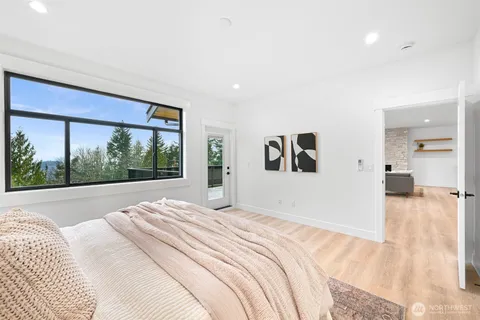 a bed room with a bed and a large window