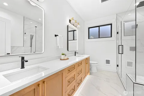 a spacious bathroom with double vanity and a mirror