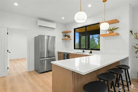 a kitchen with a stove a refrigerator and a table