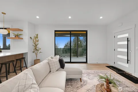 a living room with furniture and a floor to ceiling window