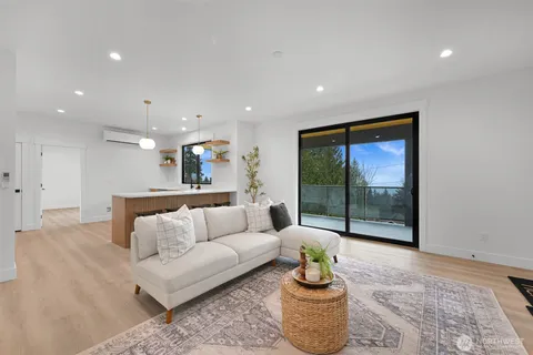 a living room with furniture and a floor to ceiling window