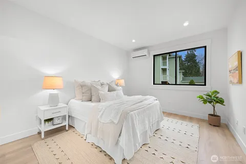 a bedroom with a bed and a potted plant