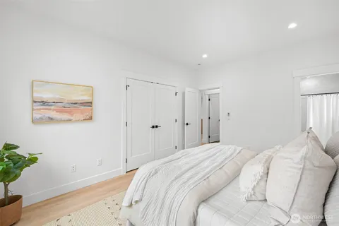 a bedroom with a bed and a potted plant