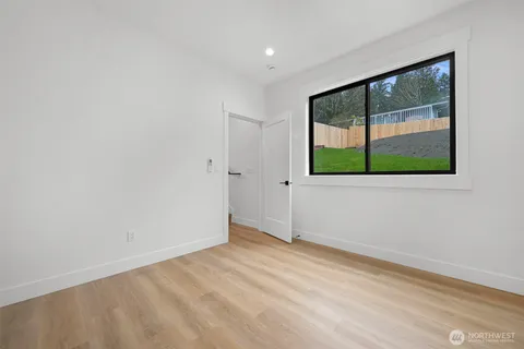 wooden floor in an empty room with a window