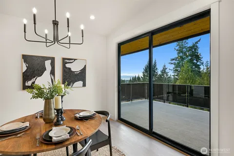 a dining room with furniture and wooden floor