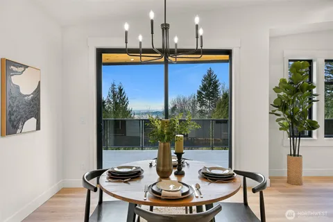 a view of a dining room with furniture window and wooden floor
